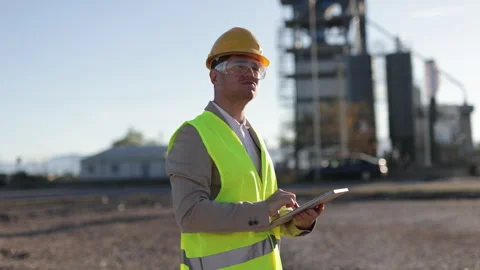 A professional heavy industry engineer stands confidently in protective gear Stock Footage 307358983
