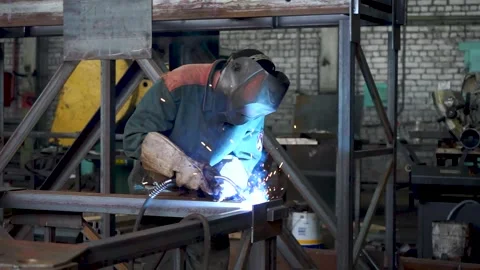 Professional Heavy Industry Welder Workin, Wears Helmet and Starts Welding Stock Footage 141928341