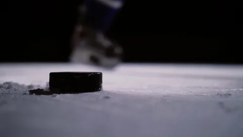 Professional hockey player produces a shot on goal at ice arena. Close-up. Slow Stock Footage