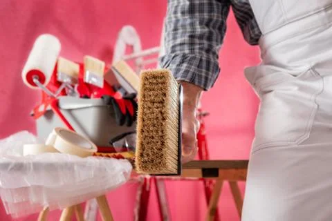 Professional house painter at work on the construction site. Stock Photos