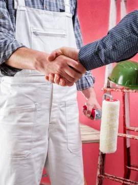 Professional house painter at work on the construction site. Stock Photos
