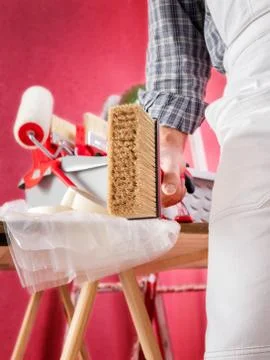 Professional house painter at work on the construction site. Stock Photos