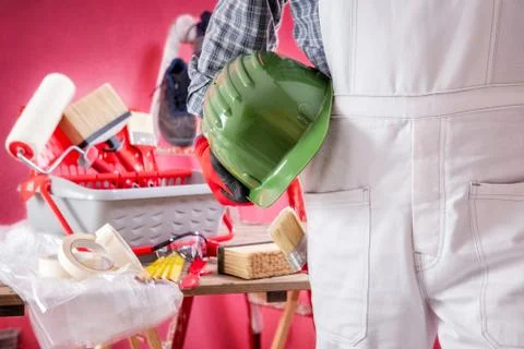 Professional house painter at work on the construction site. Building. Stock Photos