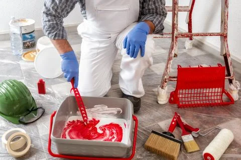 Professional house painter at work prepares the wall paint 스톡 사진