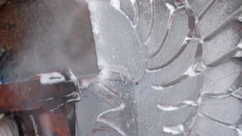 Professional ice carver making ice sculpture with electric chainsaw Stock Footage 128323055
