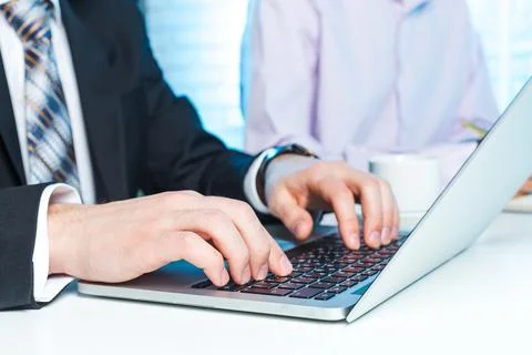 Professional individuals collaborating on a project while using modern 스톡 사진