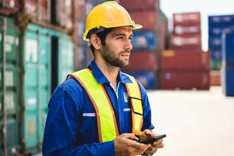 Professional industrial engineer worker working at container cargo yard Stock Photos