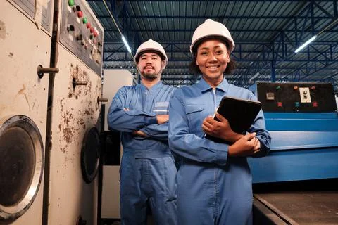 Professional industry engineers partner looking at camera and smile in factor Stock-Fotos