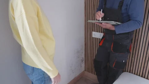 Professional inspecting mold and moisture damage for insurance assessment i.. Stock Footage 338188135