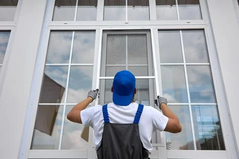 Professional installation of protective nets against insects on plastic windows Stock Photos