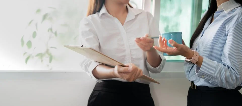 Professional interaction in office discussing performance data Stock Photos