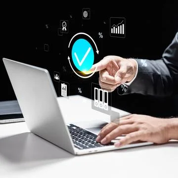 A professional interacts with a glowing checkmark and data icons on a virtu.. Stock-Fotos
