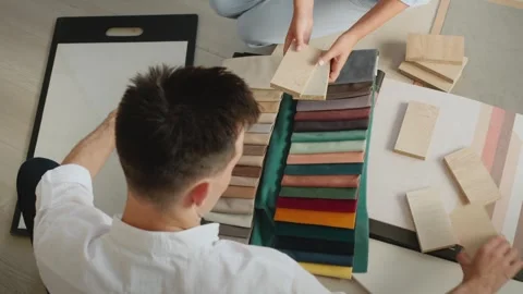 Professional interior designers comparing wooden material samples and velve.. Stock Footage 334657856