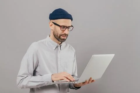 Professional IT developer downloads files, chats online in social networks, b Foto stock