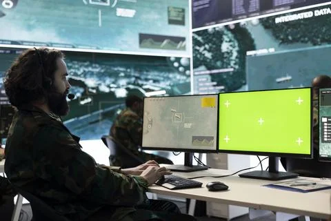 Professional IT engineer examines reconnaissance imagery and mockup Stock Photos