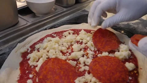 Professional Italian Chef Adding Shredded Mozzarella Cheese and Pepperoni to Fre Stock Footage 337676642