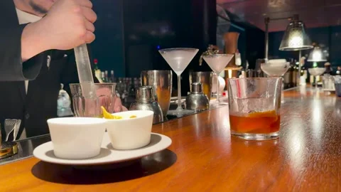Professional Japanese Bartender Using a Muddler to Prepare a Cocktail Stock Footage 334712259