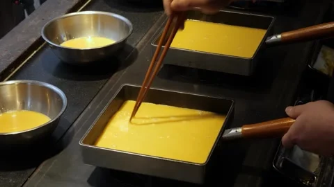 Professional Japanese Chef Preparing Authentic Tamagoyaki Rolled Omelette in Squ Stock Footage 333527252