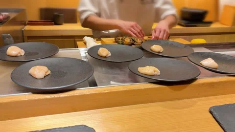 Professional Japanese chef prepping raw seafood on cutting board in Tokyo. Stock Footage 335461007