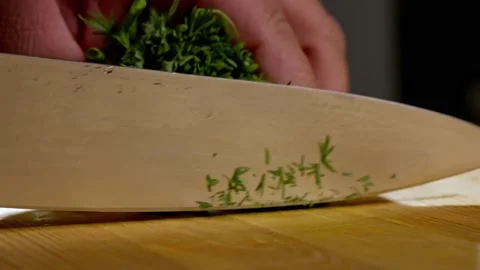 In a professional kitchen, the chef finely slices dill and onions on the cutting 스톡 동영상 236447184
