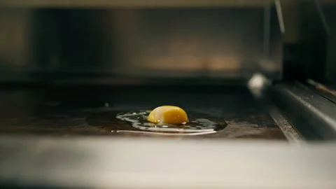 Professional kitchen in the hotel restaurant the chef breaks a chicken egg for Stock Footage 237888188