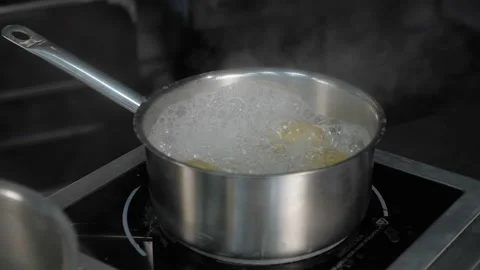 Professional kitchen of the restaurant. saucepan with boiling water on the stove Stock Footage 163971358