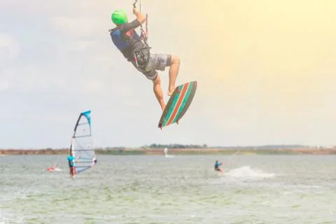 Professional kiter makes the difficult trick on a beautiful background at sun Stock Photos