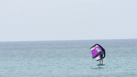 Professional kiter rides by hydrofoil Stock Footage 237156405