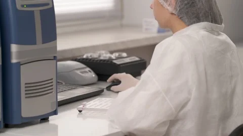 A professional lab technician loading microplate reader with mini tubes with Stock Footage 108550694