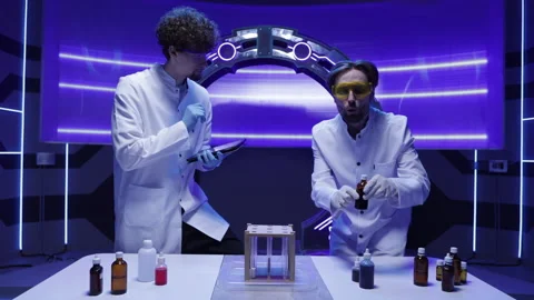 Professional lab workers in gloves and glasses testing liquids Stock Footage 239778053