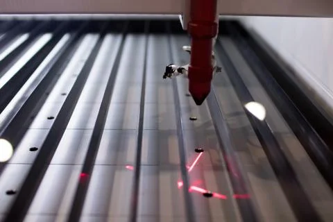 Professional laser cutting machine. laser light of a cnc plotter on the corru Stock Photos