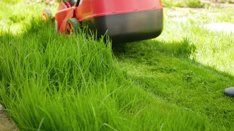 Professional lawn mower worker cutting fresh green grass Stock Footage 201473044