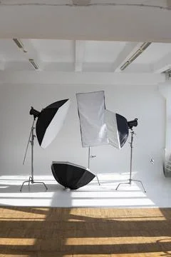 Professional lighting equipment, flashes, c-stands on a cyclorama in modern Stock Photos