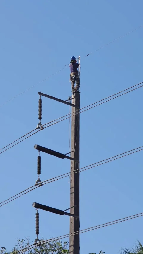 Professional lineman replacing overhead ground wire on high voltage. Stock Footage 340083801