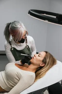 Professional lip micropigmentation procedure with thread marking technique Stock Photos