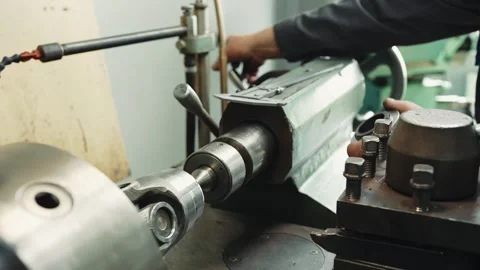 A professional locksmith turner has finished processing the part and takes it Stock Footage 285641280