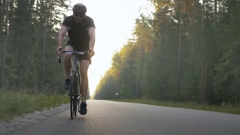 Professional long-distance cyclist training on an empty road Stock Footage 74545700