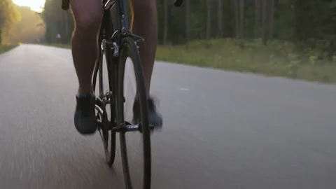 Professional long-distance cyclist training on an empty road Stock Footage 74545926