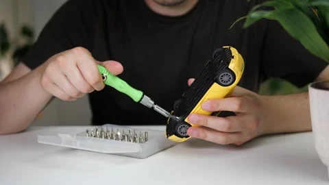 Professional macro shot of a mans hands using a screwdriver to disassemble a Stock Footage 313520714
