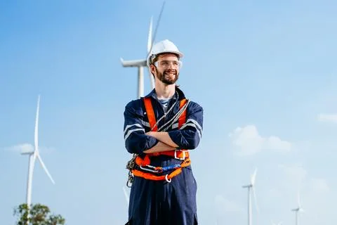 Professional maintenance engineer working at wind turbine farm Stock Photos