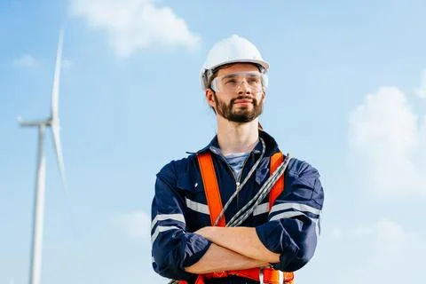 Professional maintenance engineer working at wind turbine farm Stock Photos