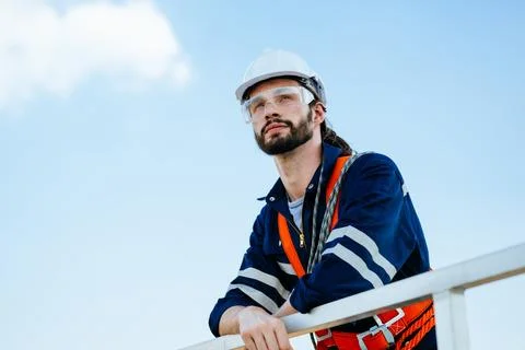 Professional maintenance engineer working at wind turbine farm Stock Photos