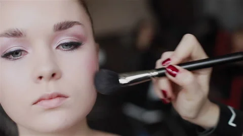 Professional make-up applying blush on cheekbones. Close-up. Front view Stock Footage 54900721