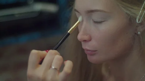 Professional make up artist Apply eyeshadows with makeup brush close-up slow Stock Footage 71707672