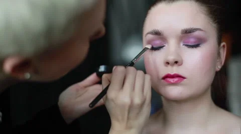 Professional make-up artist applying eyeshadow using a brush. Close up Stock Footage 52265490