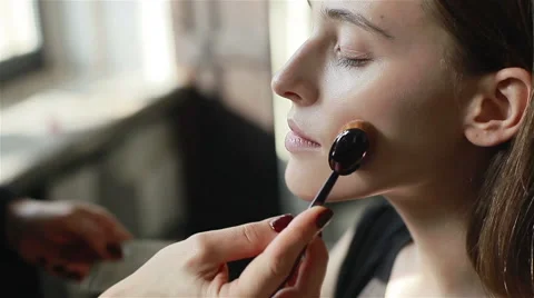 Professional make-up artist applying foundation using a brush. Close-up Stock Footage 52265857