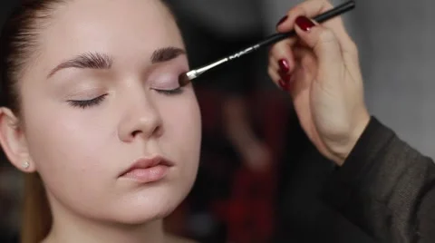 Professional make-up artist applying shadows on eyelid. Close-up Stock Footage 54625417