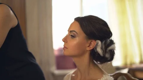 A professional make-up artist does make-up for the bride. The stylist works with Stock Footage 81252683
