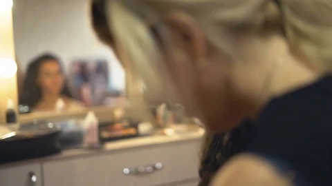 A professional make-up artist does make-up for the bride. The stylist works with Video stock 81253446