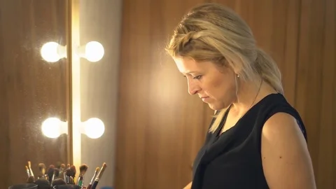 A professional make-up artist does make-up for the bride. The stylist works with Stock Footage 81253710